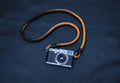 Black and gold braided leather camera strap