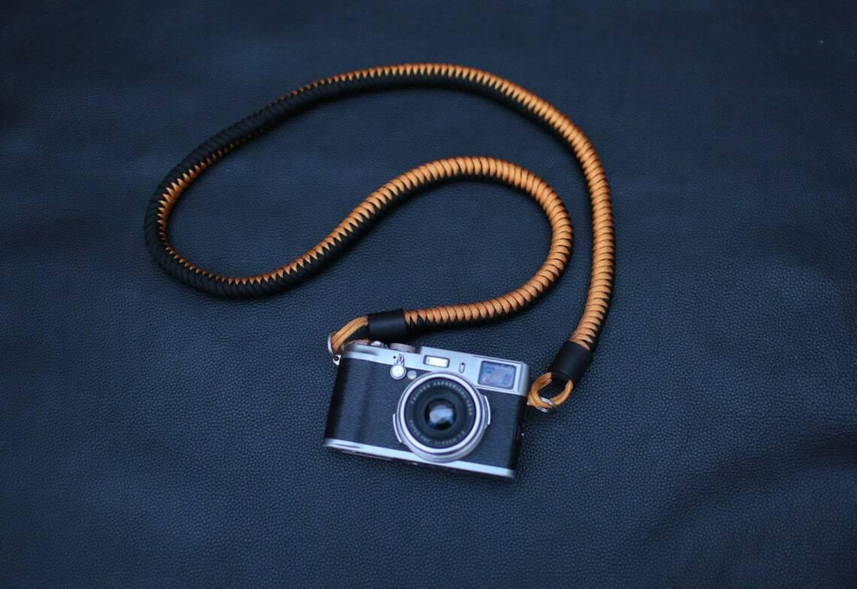 Black and gold braided leather camera strap