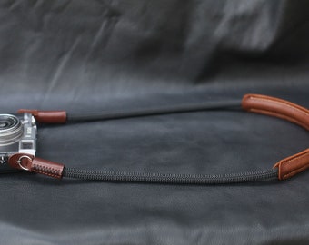 Black climbing rope camera strap with leather shoulder pad